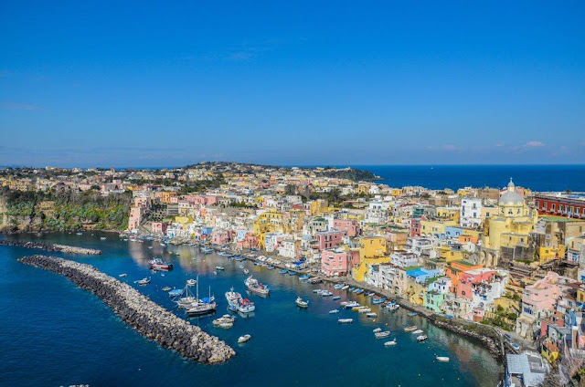 old houses of pastel color belonged to fishermen boats and sea panorama