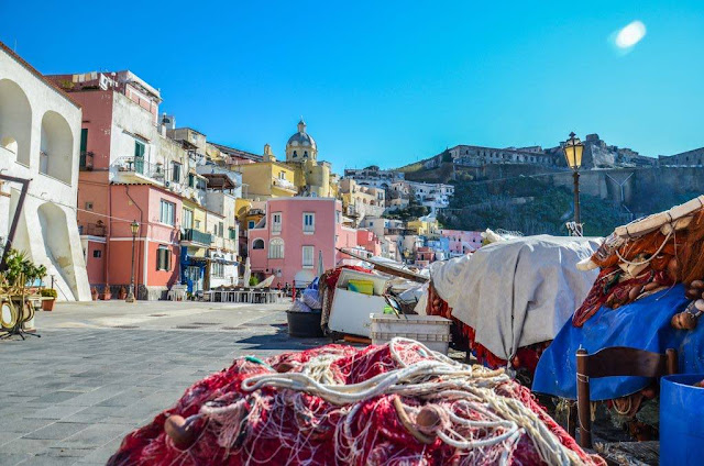 fishing nets of red color with the panorama of the colorful houses of the marina of bullfighting in the island of raccoon