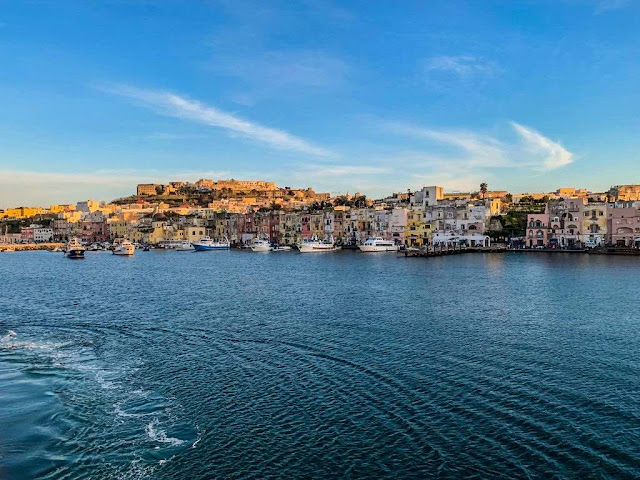 The Marina Grande port in Procida, colored old building view from the ferry boat from Naples