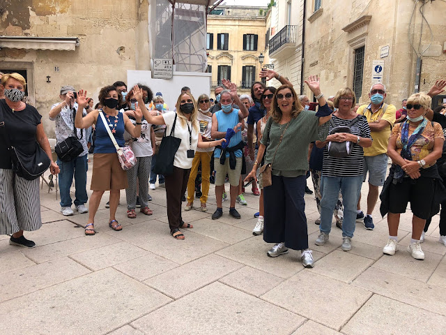 a group of people enjoy a guided tour in Lecce